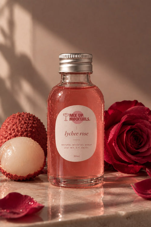 Lychee Rose Mocktail Mixer bottle with lychees and a red rose