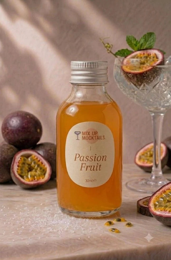 Passion Fruit Mocktail Mixer bottle with halved passion fruit